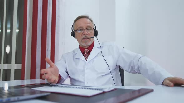 Telemedicine concept. Male doctor listening to patient talking symptom on the internet