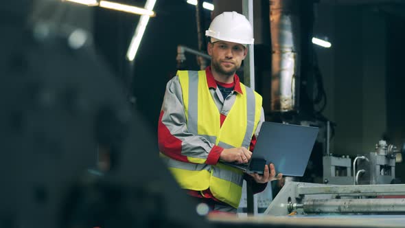 Factory Employee Is Observing Metalproducing Equipment