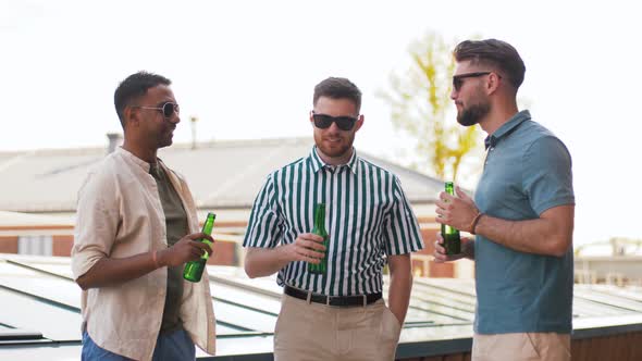 Happy Male Friends Drinking Beer at Rooftop Party