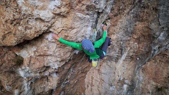 Slow Motion Aerial View Strong Moman Rock Climber Climbs on Overhanging Crag By Hard Challenging