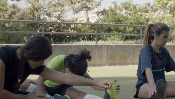 Slow Motion of Cute Women Stretching Legs at Football Stadium