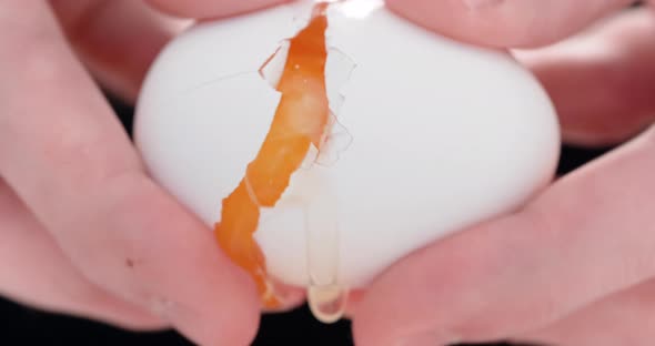 4K - Cook breaks an egg. Close-up