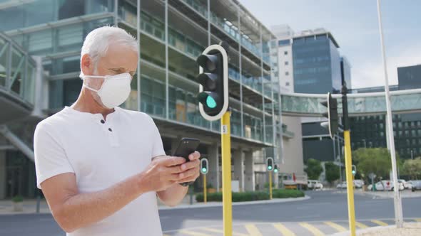 Caucasian man out and about in the street wearing on a face mask against coronavirus