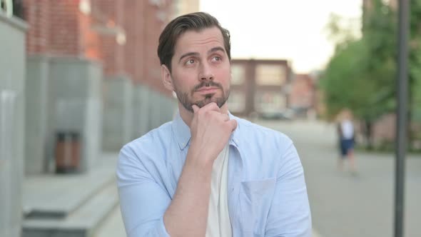 Pensive Man Thinking While Standing Outdoor