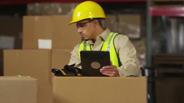 Industry worker using digital tablet in shipping warehouse