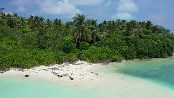 Wide angle drone island view of a paradise sunny white sand beach and aqua blue water background 