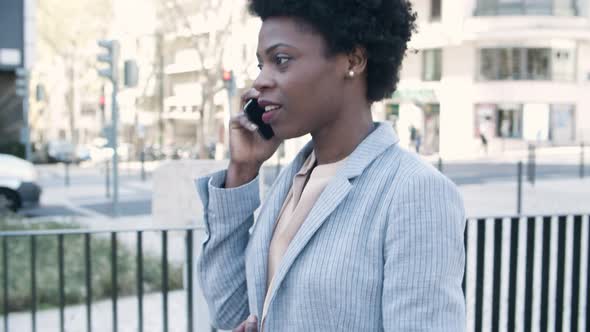 Beautiful Smiling Woman Talking on Phone During Stroll