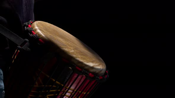 Black Man Drummer Rhythmically Beats Hands on the African Drum in the Studio Closeup