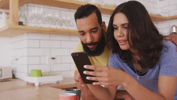 Happy couple using smartphone