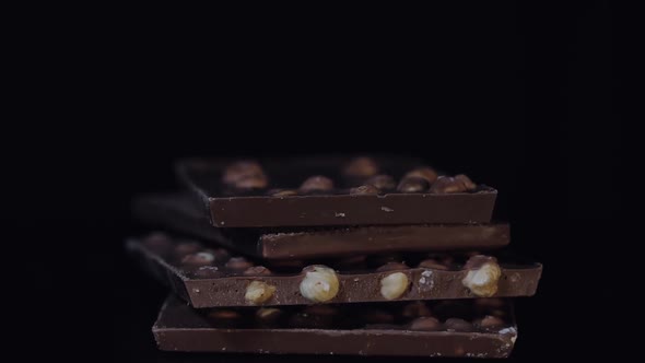 Dark Chocolate Blocks with Nuts Details Slow Close-up Macro. Chocolate Bars