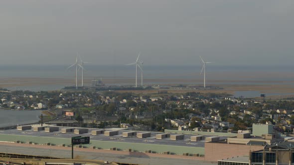 Aerial of flyover, city settlement and windmills in Atlantic city