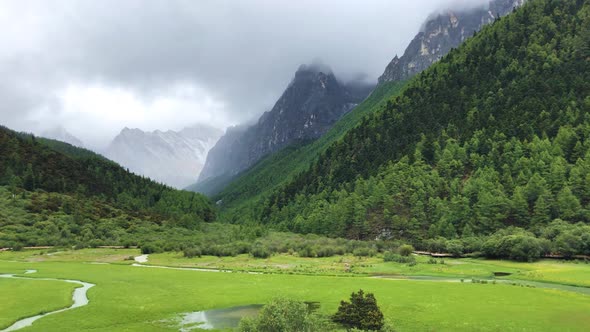 A Cloudy Mountain Peak in Valley Forest