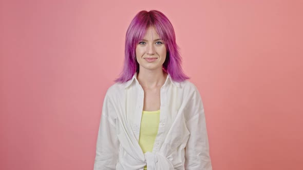 Purplehaired Woman Catches Present in Studio Closeup