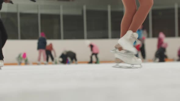 Close Up on the Starts Figure Spinning on the Ice Rink