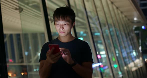 Man Use of Mobile Phone in City at Night