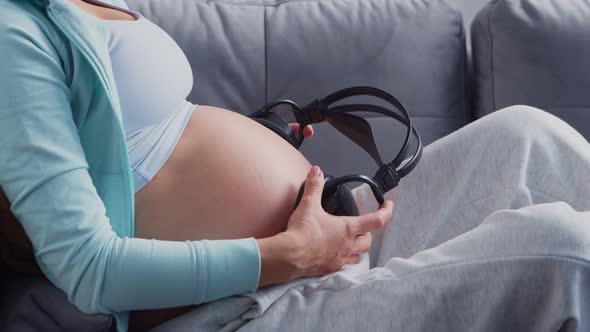 Young pregnant woman is resting at home and expecting a baby.