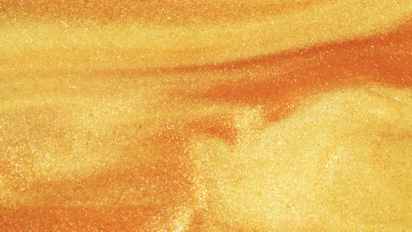 Colorful Golden Sand Organically Moves in Colorful Liquid in Macro alt