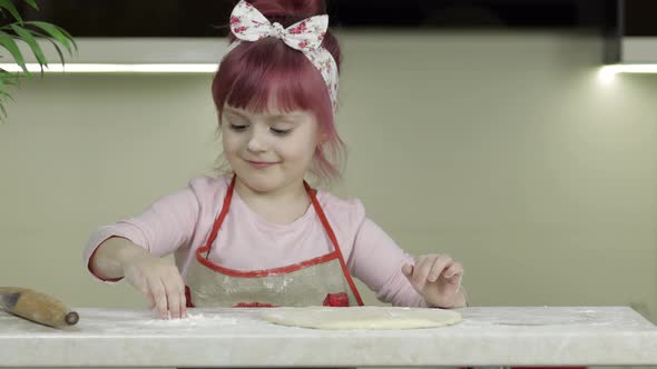 Cooking Pizza. Little Child in Apron Sprinkle the Dough with Flour in Kitchen