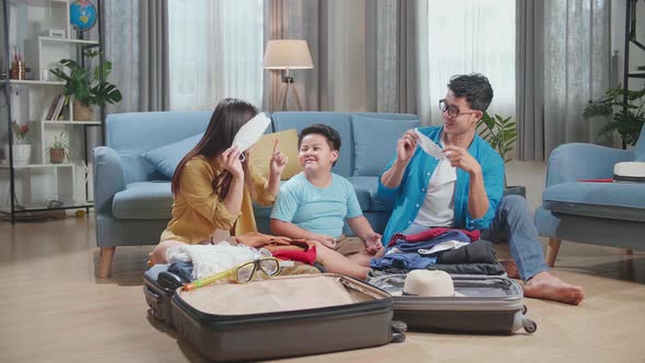 Family Packing Clothes And Protect Mask In A Suitcase For A New Journey. Luggage For Travel Holidays
