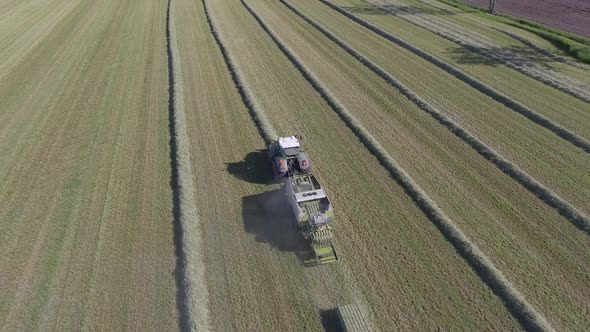 aerial hay field production overview rising reveal angle 4k