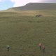 Drone Shot of a Group of Tourists Climbs the Mountain - VideoHive Item for Sale
