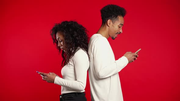 Couple Stand,printing Messages. Woman Is Peeking Over Boyfriends Shoulder