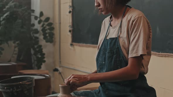 Woman Making Small Vase on Pottery Wheel