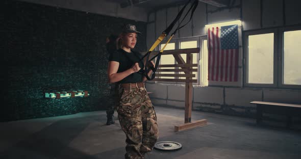 Sweaty Female Soldier Exercising in Gym