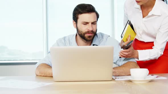 Executive getting frustrated while working at his desk