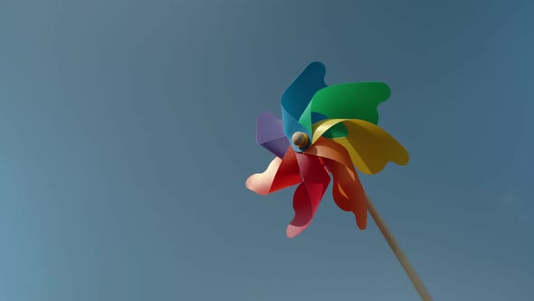 Colorful Paper Windmill Against the Blue Sky