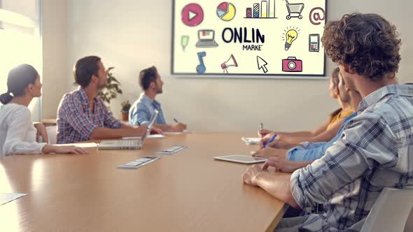 Team of executives looking at the presentation in the conference room