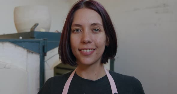 Young female potter working in her studio