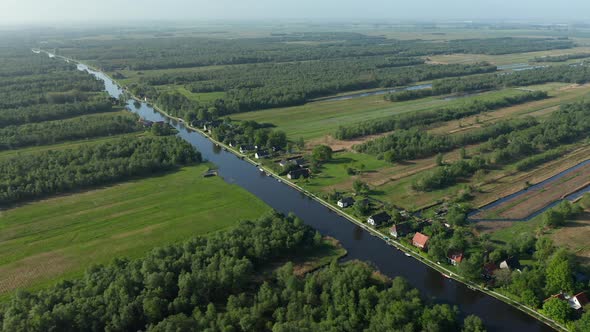 Scenic View Of River Watercourse In Dense Forestland In Ossenzijl, Friesland, Netherlands. Aerial Wi