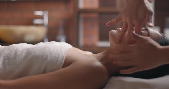 Woman Getting A Face Massage in Spa Salon