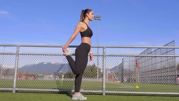 Athletic girl stretching hamstrings before running Slow motion