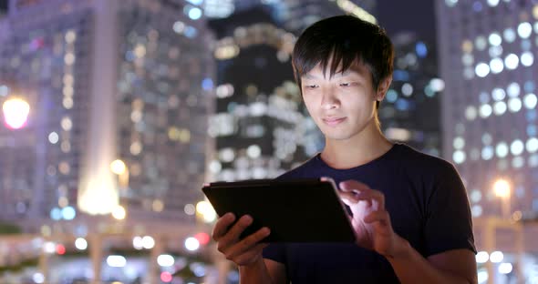 Asian Man Use of Tablet Computer at Outdoor