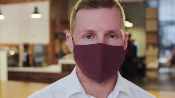 Doctor Video Footage - A Man Wearing Maroon Face Mask While Looking At The Camera