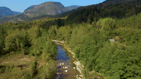 steep green mountains, deep forest and mountain road, beautiful valley and river