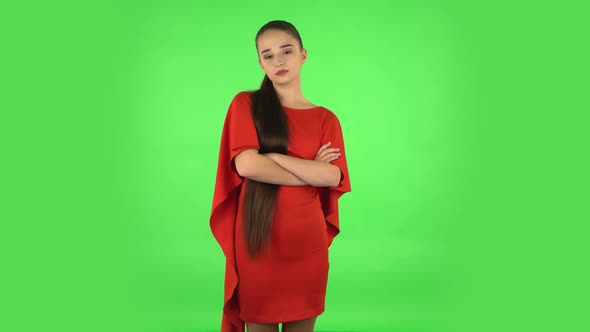 Pretty Young Woman Is Standing Offended and Then Smiling. Green Screen