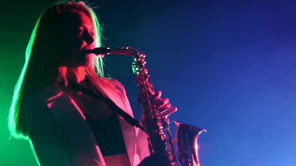 Young Sexy, Blonde Woman Dj in White Jacket and Black Top Playing Music Using Saxophone, Flipping