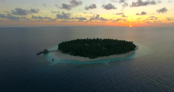 Aerial drone view of scenic tropical islands at sunset in the Maldives.