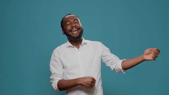 Male Hipster Playing Air Guitar and Having Fun with Music