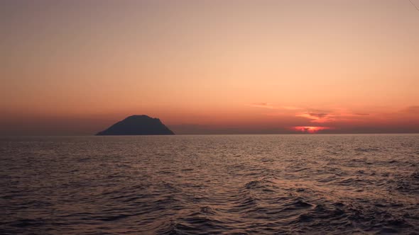 Lipari Island in Mediterranean Sea Against Horizon. Colorful Sky, Summer Sunset or Sunrise. Rippling