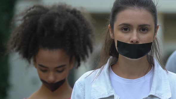 Female Activists Demonstrating With Taped Mouth, March Against Domestic Violence