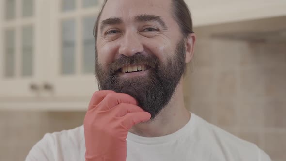 Portrait of Handsome Man with Perfect Beard Smiling After Working and Cleaning All His New Modern