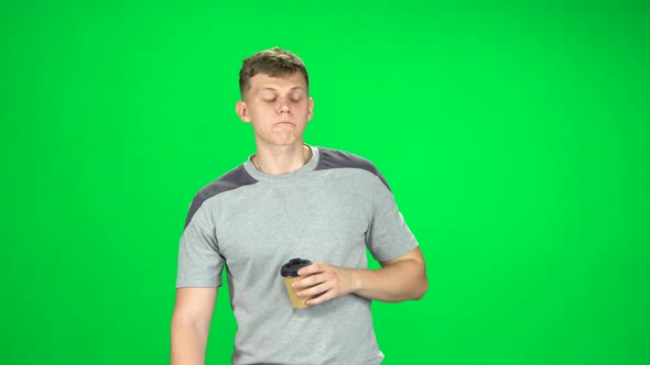 Guy Is Walking and Drinking Coffee From a Paper Cup. Chroma Key
