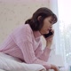Young woman talking mobile phone and crying in bedroom - VideoHive Item for Sale