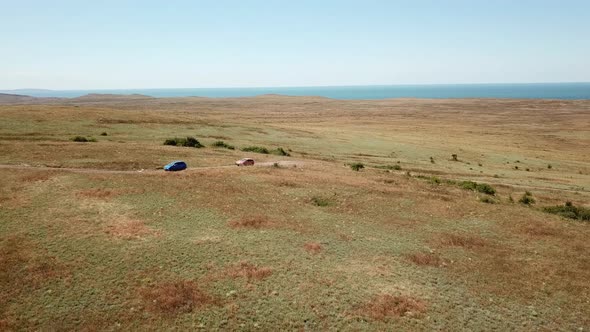 Aerial view. Cars go across the field. General's beaches, Crimea