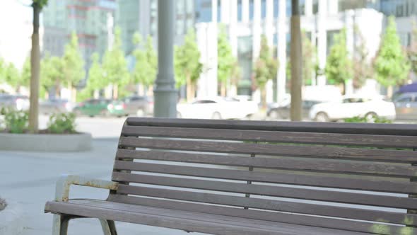 African Man Coming and Sitting on Bench Outdoor