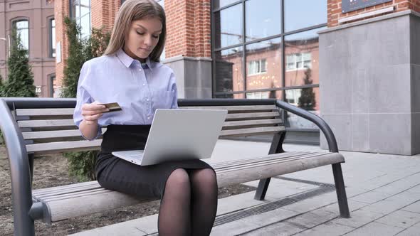 Woman Busy Doing Online Shopping On Laptop, Sitting Outside Office